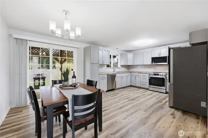 Bright dining area with sliding glass door to the backyard, ideal for entertaining and seamless indoor-outdoor flow.