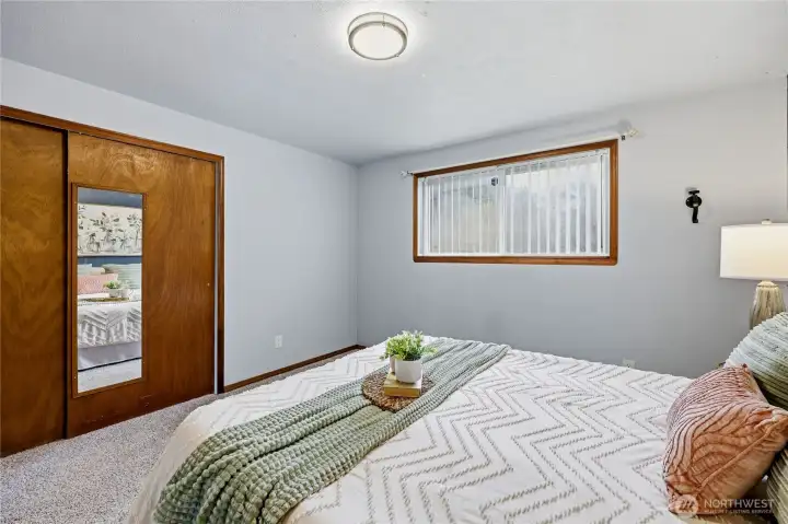 Another look at the primary bedroom highlighting its natural light and spacious feel.