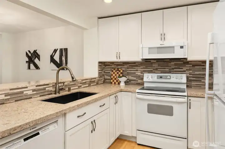 Modeled kitchen with quartz counters, newer cabinets, updated lighting - just turn key!