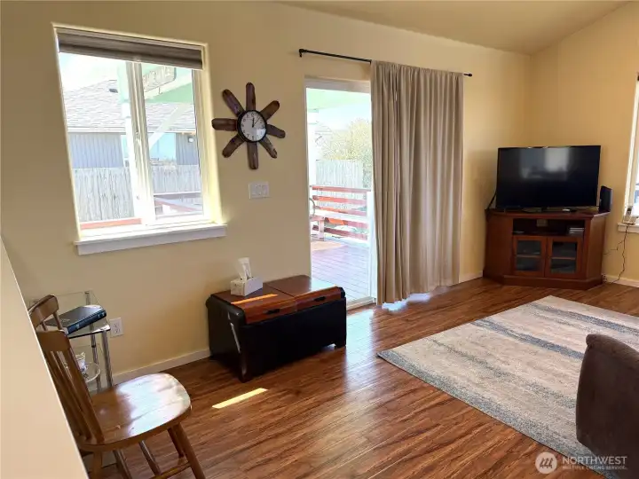 Laminate flooring throughout the home. Sliding doors out to the covered deck.