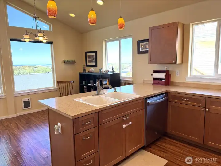 Large sink and dishwasher with an ocean view.
