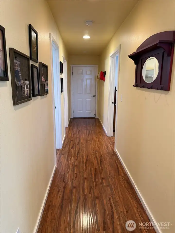 Hallway leads to guest bedroom, full bath, Primary bedroom, laundry and garage.