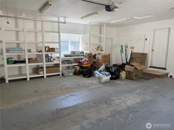 Large garage with lots of shelving.