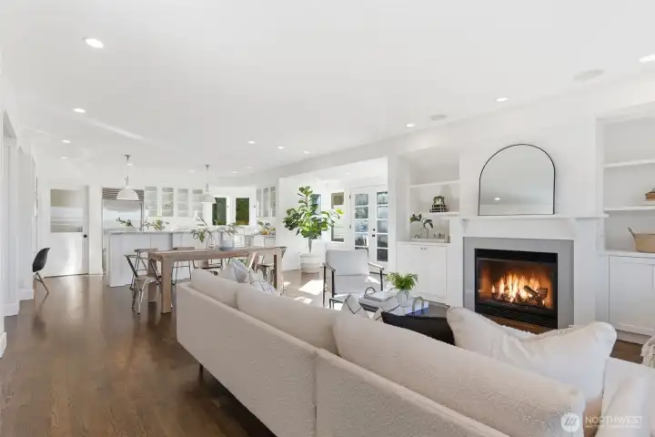 Custom, hand-built shelves and carefully designed fireplace mantel are a modern take on heritage designs. In ceiling speakers and prewire for surround. Electronics may be stored in the lower righthand cabinet, with tubing running up to wall above fireplace. There is also a flush wood floor plug under the sofa.