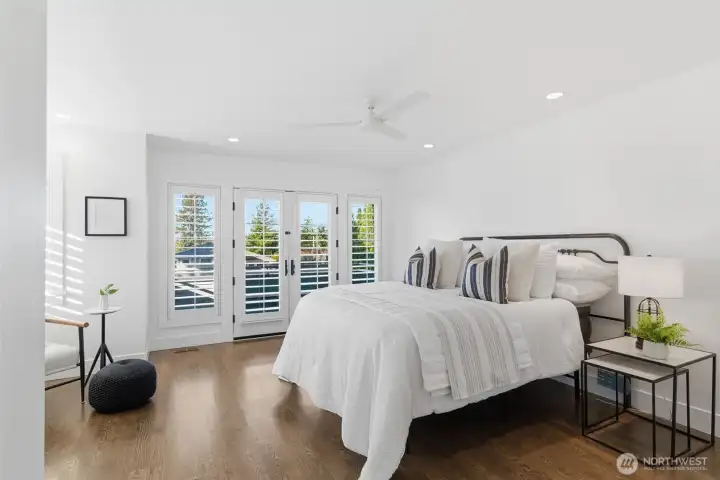 The primary bedroom is perched high above the street for a magical, tree-house feel. Stunning sunsets and snippets of Lake Washington offer a calming sense of place.