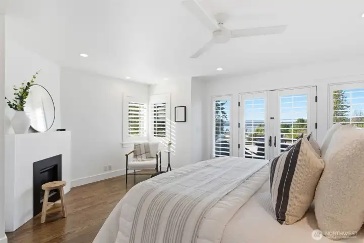 A minimalist fireplace and space and sitting area make this a true retreat.