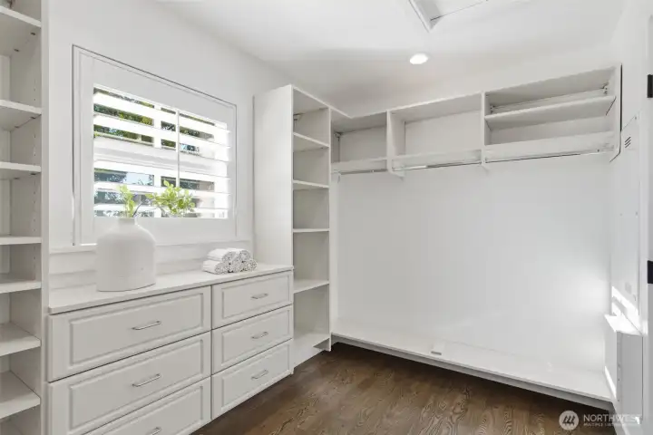 Lovely walk-in closet with hardwood floors and sweet awning window facing the lake.