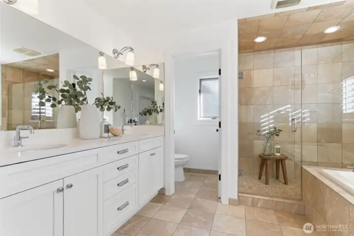 Dreamy Waterworks faucets, soft white quartz, and in-floor heat – plus an oversized shower and large  soaking tub. Lighting and hardware from Restoration Hardware.