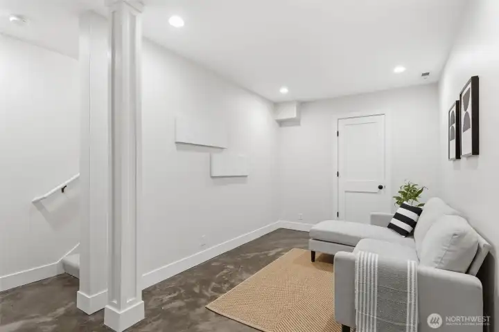 Downstairs, a bonus room with concrete floors. Wired for surround and tubing to connect any electronic components to the large storage closet (via door shown). Beyond the storage closet is a separate mechanical room, which has an additional storage closet attached.