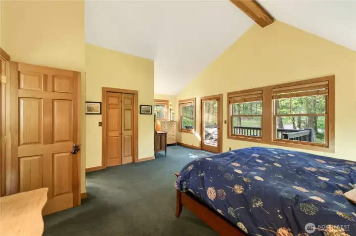 Upstairs primary bedroom with balcony walk in closet and full bathroom