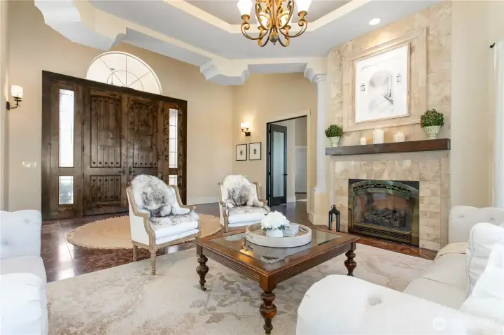 View from the front living area to the front entry. The massive 10' wood doors are a focal point.