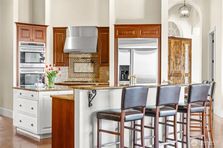 The spacious kitchen has lots of storage including a butler pantry, walk-in pantry, and is great for entertaining with Wolf double ovens, a warming drawer, and a 5-burner gas range.
