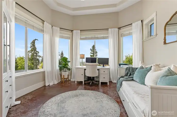3rd bedroom downstairs with bay and lake views, shown here as a second office