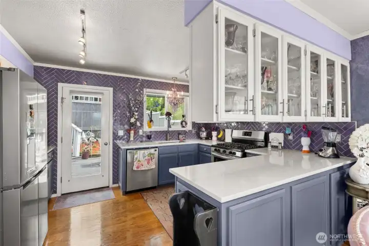 Open Kitchen with Entry to back patio/deck.