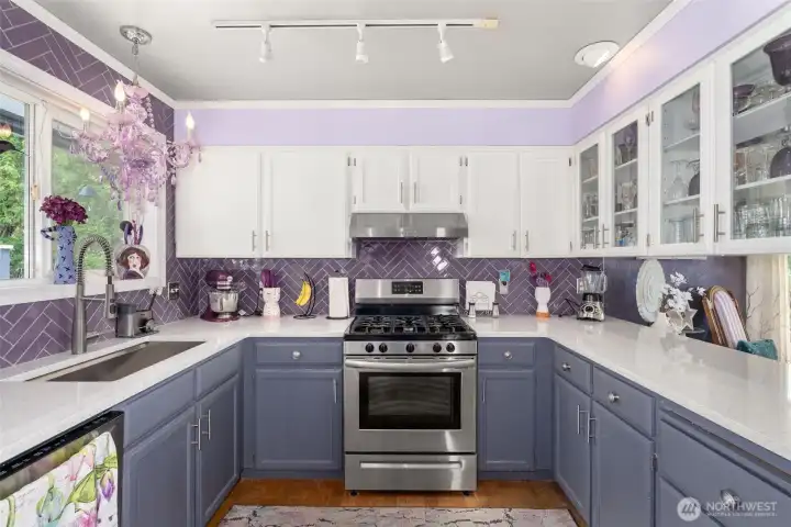 Quartz Counters with beautiful accents and stainless-steel appliances.