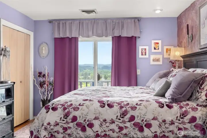 Primary Bedroom with private deck and view of city.