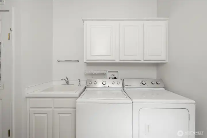 Separate Laundry Room with cabinets and sink