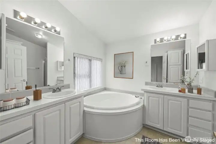 Large soaking tub and dual vanities
