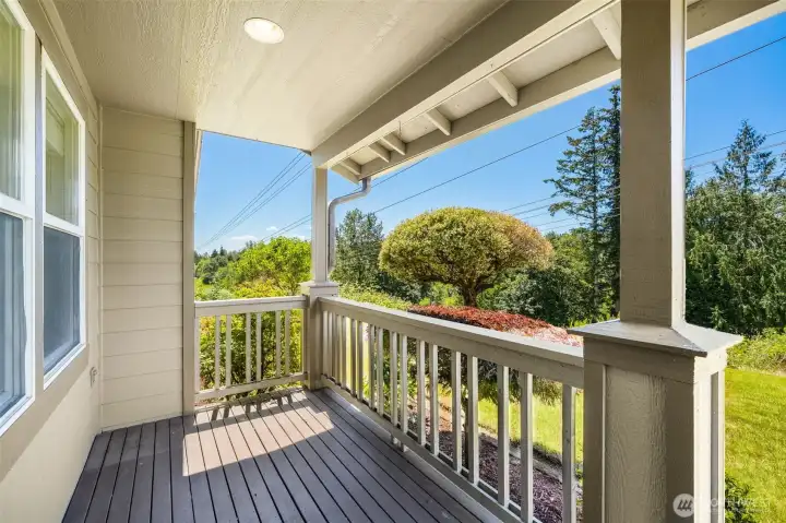 Front porch overlooks private green setting
