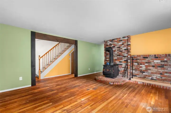 The front living room looking toward the stairs and the entrance to the kitchen, dining area and family room.