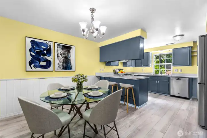 The dining area and kitchen. This photo is virtually staged.