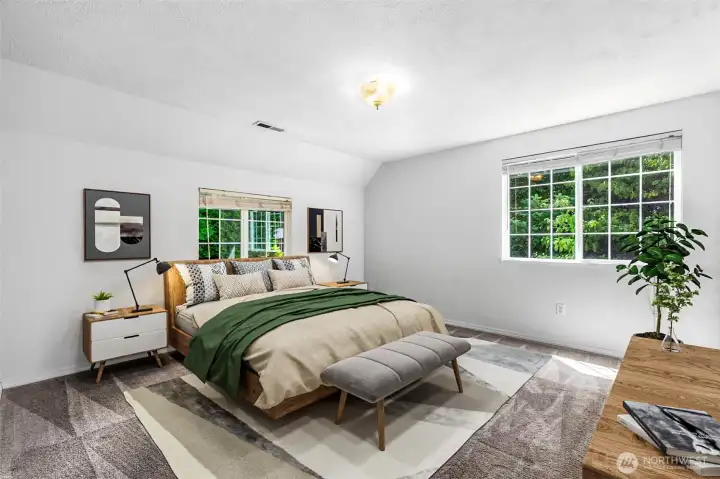 The spacious primary bedroom. This photo is virtually staged.