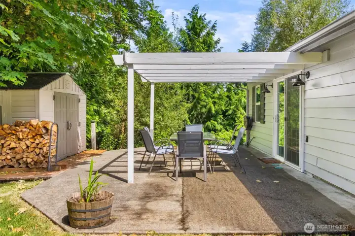 Back yard patio is a great space to relax end enjoy the landscaped yard. Useful Tool shed and the wood pile stays.