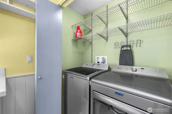 Laundry closet is just off the kitchen. The washer and dryer stay with the home.
