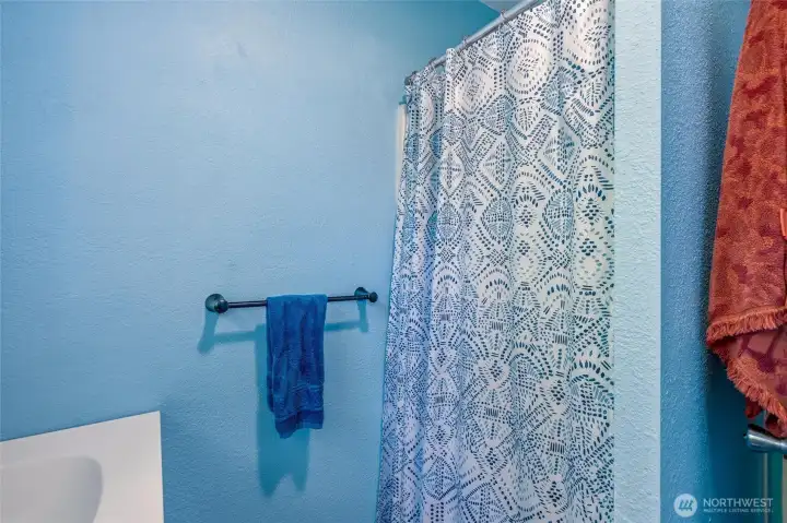 There is a shower in the bathroom. There is a shower in the bathroom.