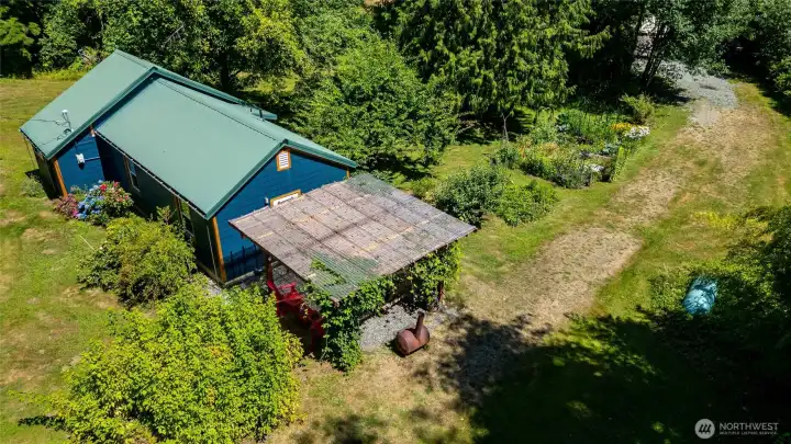 A view of the home looking back down towards the back of the property where the yurt is located. A view of the home looking back down towards the back of the property where the yurt is located.