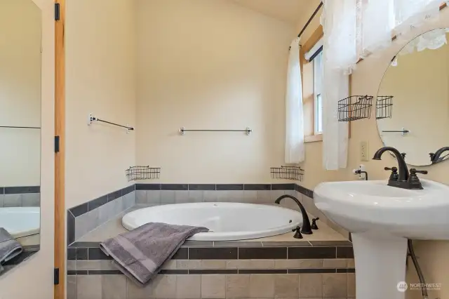 This wonderful soaking tub awaits you upstairs.