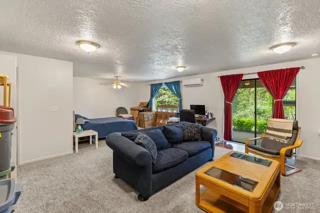 Light and cheery lower living area with patio access