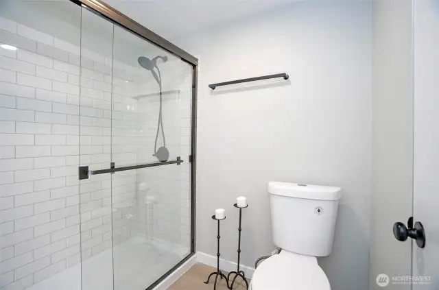 The primary bath features a beautifully tiled walk-in shower. Elegant yet functional.