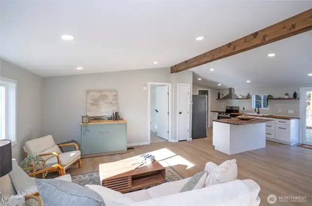 Admire the aesthetic appeal of the wood wrapped beam which matches the kitchen countertops.