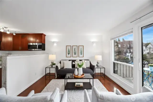 Relax in the open living space with glass sliding doors and a wall of windows.