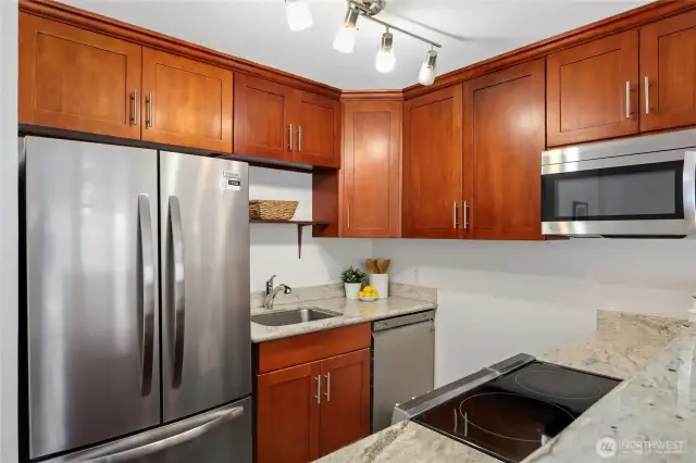 Ample counter space to prep meals along with prepping area. Granite counters and electric 4 burner cooktop.