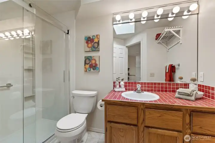 2nd floor guest bathroom with new shower and glass enclosure.