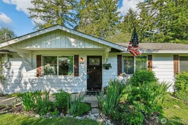 Front, exterior of home with walkway and landscaped yard.