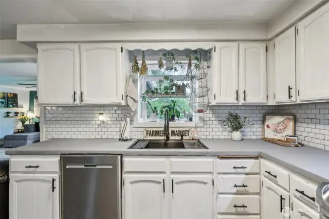Kitchen w/ a built in window, providing shelving & hooks above sink for added storage