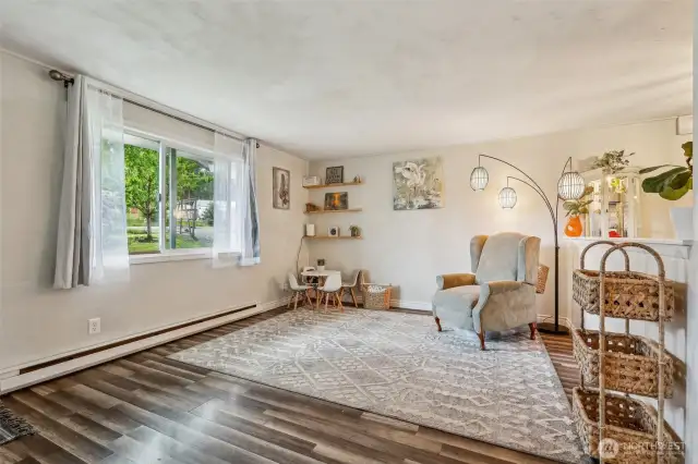 Front room w/laminate hardwood flooring throughout home