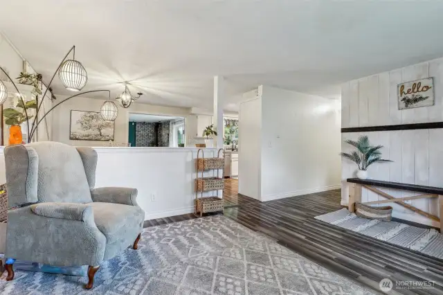 Front room w/view into kitchen w/window located over sink to view back deck overlooking property.