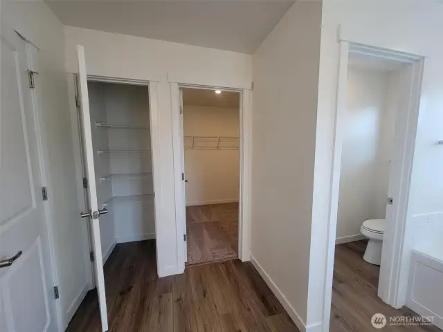Linen, toilet room and walk in closet off primary bathroom