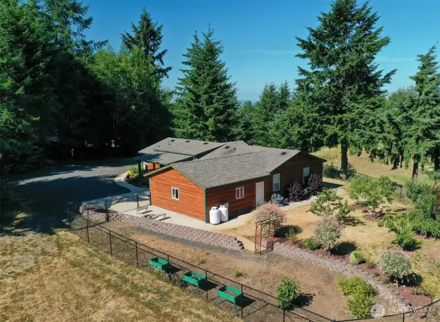 Nicely landscaped yard with a chicken coop.