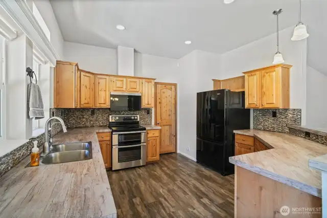 Kitchen features a new stove, dishwasher, and built-in microwave/air fryer combo, complemented by a spacious pantry for all your storage needs.