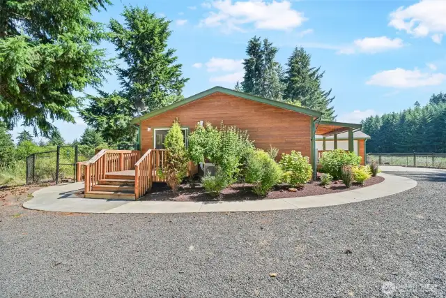 Beautifully crafted custom concrete sidewalks surround the home, enhancing both curb appeal and functionality.