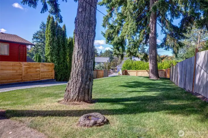 You start to relax as soon as you open the gate! A driveway lined with peaceful evergreens delivers you to your front door. Yard is completely fenced for maximum privacy and security.