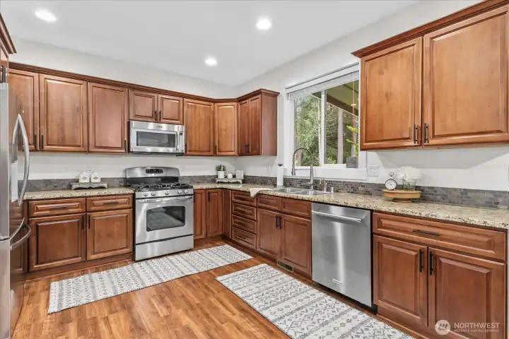 Nicely appointed kitchen with granite countertops. Refrigerator, microwave and dishwasher are newer. Seller had mobile island (now shown on back deck)