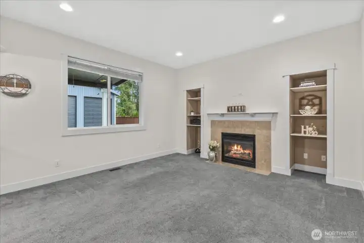 Family room with fireplace, built-ins. Flatscreen plumbed for above mantle