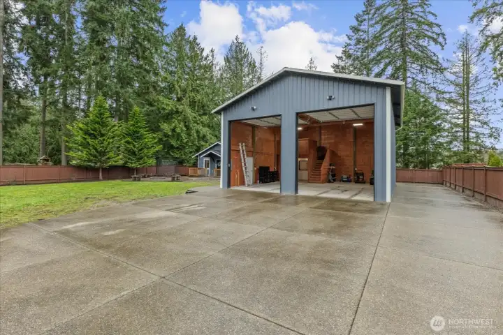 Shop roll-up doors are 14'. Depth of shop is 36'. Width is 30'. Overall height is approximately 20'. Notice stairs-mezzanine and 3/4 bath in back left. There's still room to park a full-size truck in left bay