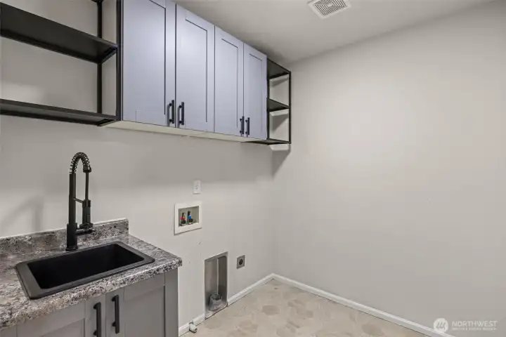 Upper floor Utility Room convenient with sink and newly installed shelves
